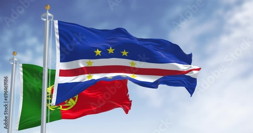 Cape Verde national flag waving iwaving with the portuguese flag on a clear day photo