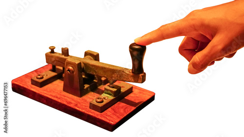 Close up of a telegraph key being used by an operator to make morse code and communicate, isolate on white background. photo