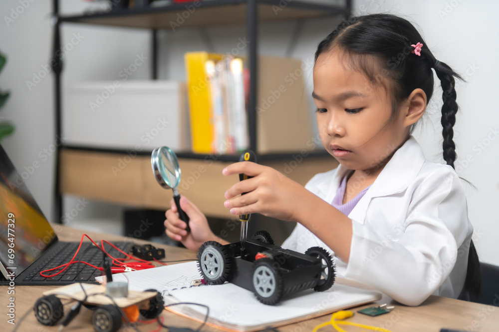 Asian littlle girl constructing and coding robot at STEM class,Fixing and repair mechanic toy car Asian littlle girl constructing and coding robot at STEM class,Fixing and repair mechanic toy car