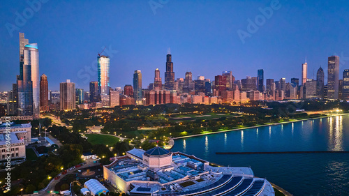 Aerial above aquarium with city lights at night reflection on Lake Michigan harbor water, Chicago IL photo