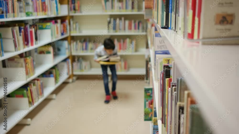 Child in public bookstore with books. Concept of education, imagination and public library. Stimulate children's image, education, and interest in science, curiosity, and reading. Child in public bookstore with books. Concept of education, imagination and public library. Stimulate children's image, education, and interest in science, curiosity, and reading.