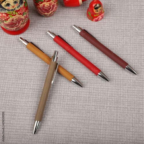 Colorful leather pen. Concept shot, top view, different colors pens. Blank space for text. Special background pen view.