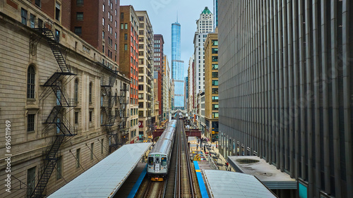 Train traveling toward Trump Tower, tourism with downtown skyscraper buildings, Chicago aerial photo