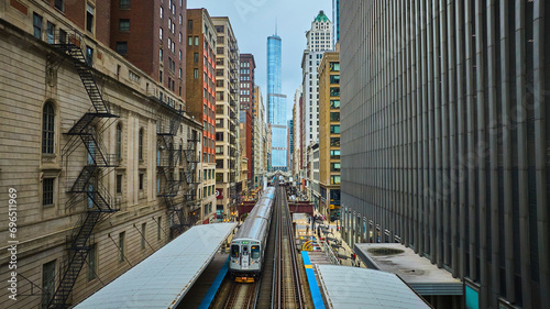 Train traveling toward Trump Tower, tourism with downtown skyscraper buildings, Chicago aerial