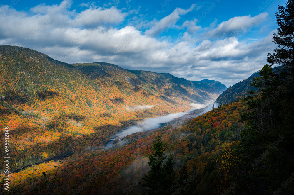 Foggy colorful valley of the Jacques Cartier river on a wonderful Autumn day, Quebec, Canada