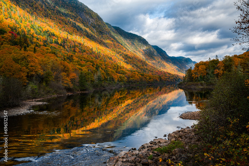 Majestic Fall foliage colors in the Jacques Cartier valley as the river flows slowly, Quebec, Canada