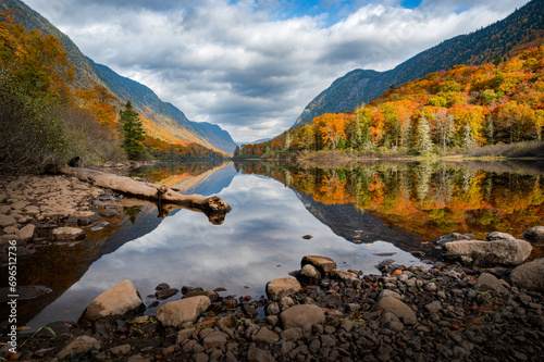 Majestic Fall foliage colors in the Jacques Cartier valley as the river flows slowly, Quebec, Canada