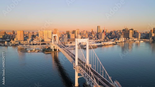 tokyo city skyline aerial view drone of rainbow bridge at sunrise dawn,downtown waterfront in the background photo