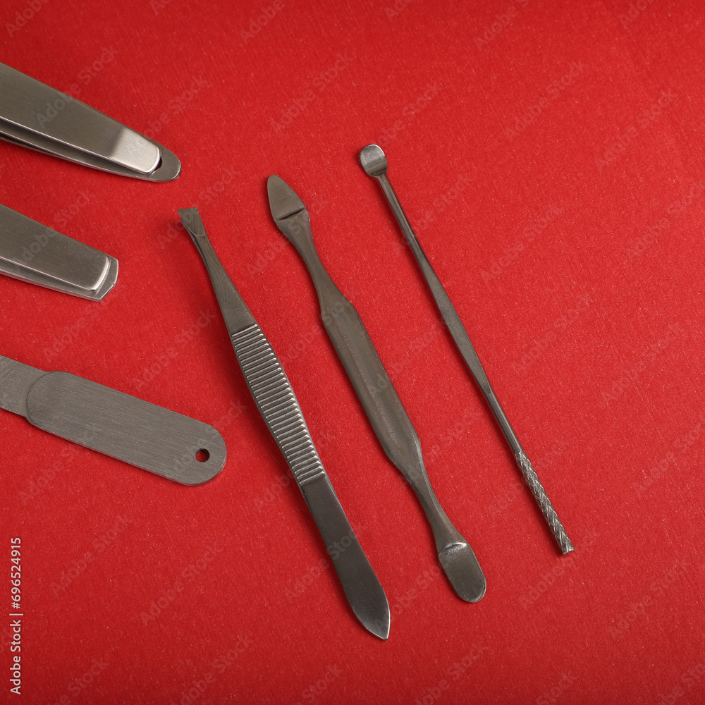 Manicure set kit in Colorful leather case. Concept shot, top view, different colors Manicure set. Special background Manicure set view. Red background. Manicure set kit in Colorful leather case. Concept shot, top view, different colors Manicure set. Special background Manicure set view. Red background.