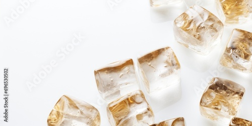A group of ice cubes sitting on top of a white surface. Perfect for beverage, summer, or cooling concepts
