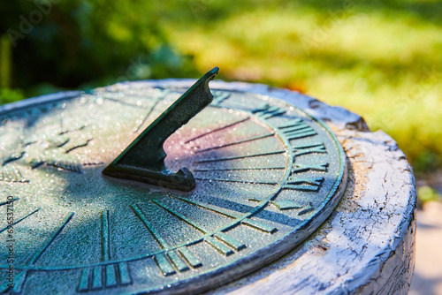 Fotografie Vintage Sundial in Garden with Morning Dew, Close-Up Perspective