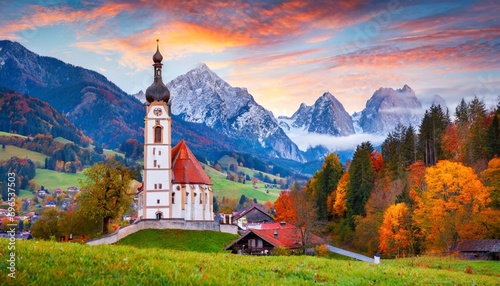 iconic picture of bavaria with maria gern church with hochkalter peak on background fantastic autumn sunrise in alps superb evening landscape of germany countryside traveling concept background photo