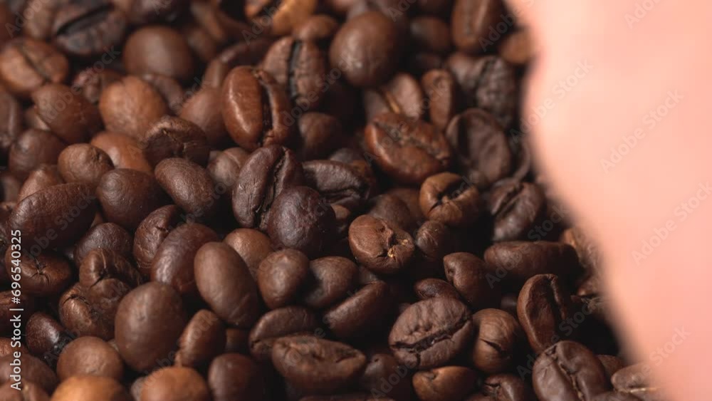Aromatic coffee grains lie before making coffee, a man takes coffee grains Aromatic coffee grains lie before making coffee, a man takes coffee grains