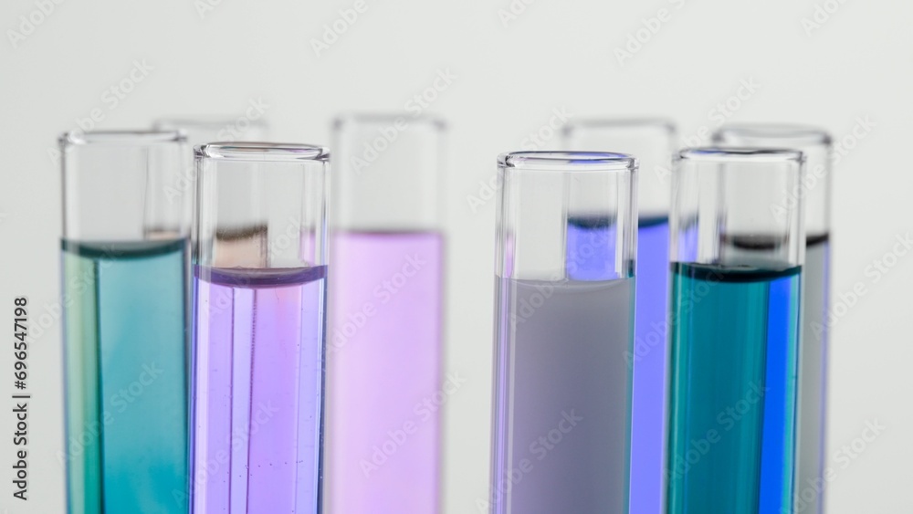 Close up shot of laboratory glassware on white background. Test tubes with colorful liquids in laboratory, scientific expertise. Close up shot of laboratory glassware on white background. Test tubes with colorful liquids in laboratory, scientific expertise.
