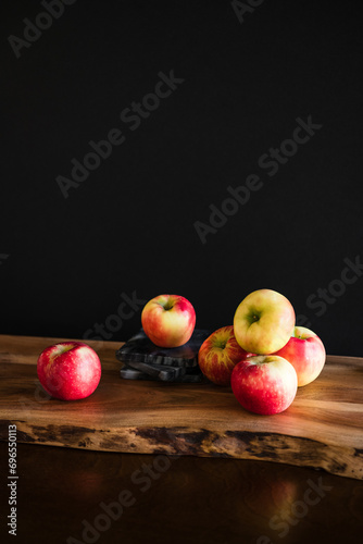 Group of red and yellow apples healthy fresh food on wooden table with dark moody background room for copy