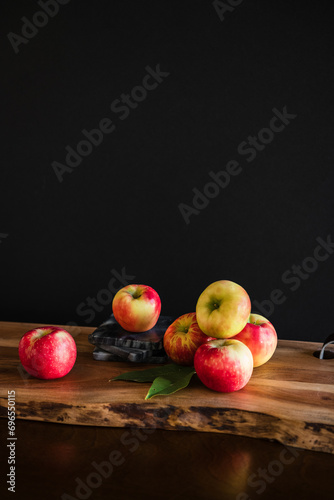 Group of red and yellow apples healthy fresh food on wooden table with dark moody background room for copy