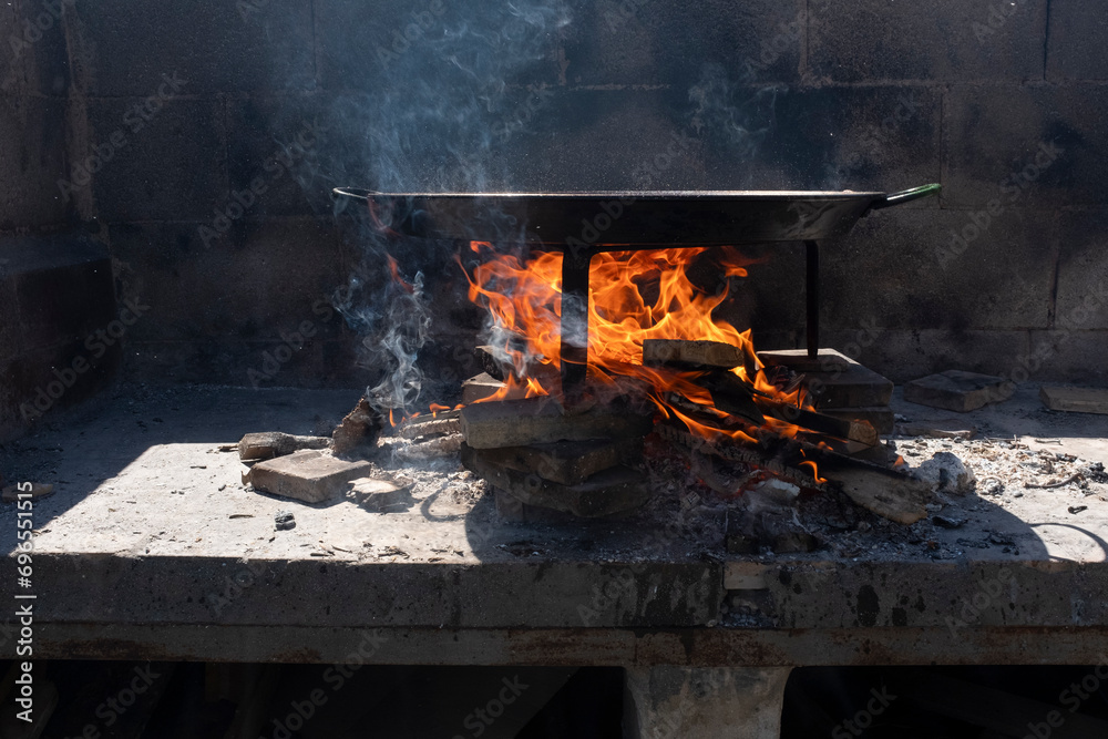 Paella, a traditional and famous Valencian food cooked with wood Paella, a traditional and famous Valencian food cooked with wood