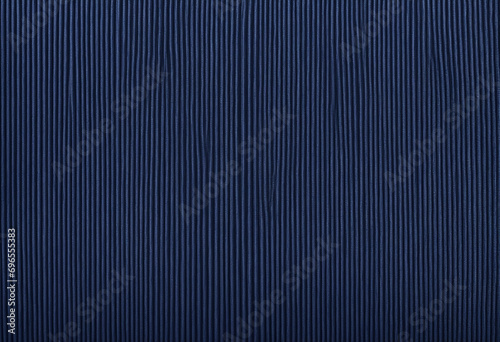 Deep Navy Corduroy Fabric Texture. Sophisticated Background for Creative Space. Natural Ribbed Cotton Material. Robust Textile Detail. Close-Up View. photo
