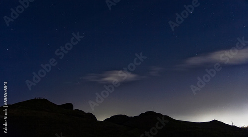 Northumberland night sky over Northumberlandia with stars, cloud and light pollution. photo