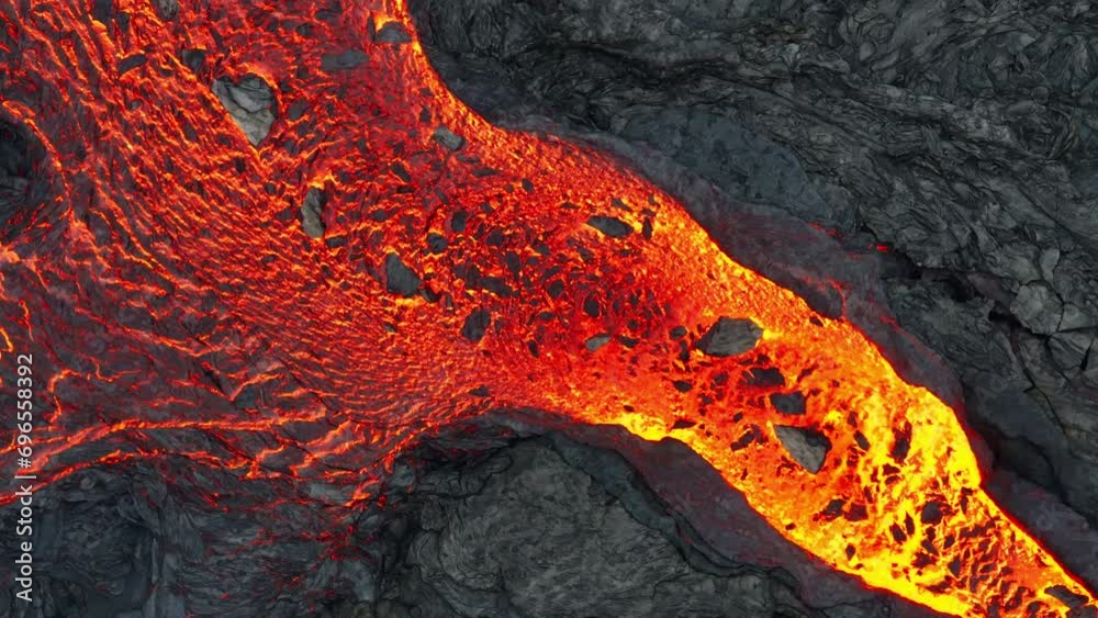Aerial drone view over river of molten hot lava erupting from the Litlihrutur Iceland volcano and flows through dark rock in 2023. Tourist attraction to beautiful and dangerous disaster.