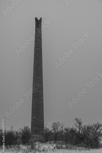 Rana hill in white storm snowy morning near Louny town with ruin chimney photo