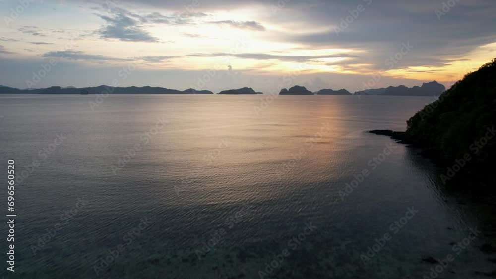 Drone flies up to show island in the Philippines at dusk Drone flies up to show island in the Philippines at dusk