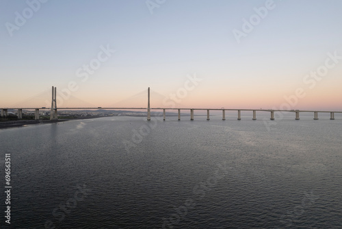 sunset over the ocean and second longest in europe bridge vasco da gama in lisbon portugal