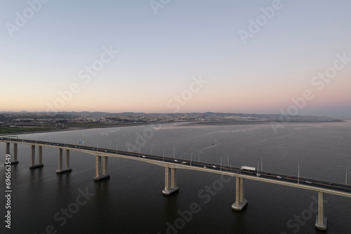 sunset over the ocean and second longest in europe bridge with cars driving vasco da gama in lisbon portugal © Nike Ossler