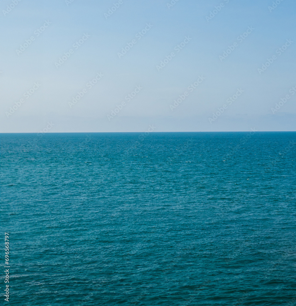 Obraz premium Vertical front viewpoint Leam Ya mountain landscape sea sky blue clear background no cloud day time look calm summer Nature tropical beautiful pacific ocean wave water nobody travel exotic horizon.