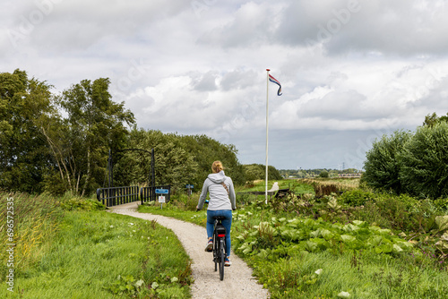 Cycling along lake Schildmeer between Schildwolde en Overschild in municipallity MIidden-Groningen Groningen province in The Netherlands photo