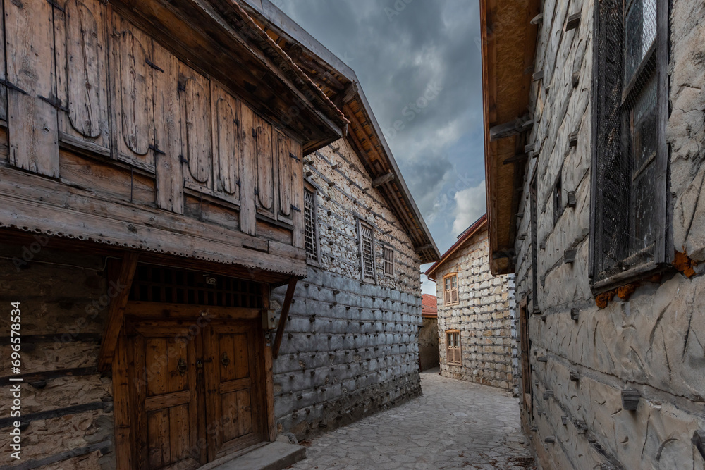Old houses made of wood, stone and mortar, empty streets.