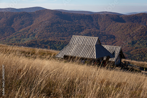 Fototapeta Naklejka Na Ścianę i Meble -  View of the Bieszczady Mountains from Połonina Wetlińska. Barn in the mountains during autumn sesion. 