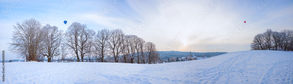 snowy winter landscape with bare trees at the hill and hot-air balloons snowy winter landscape with bare trees at the hill and hot-air balloons