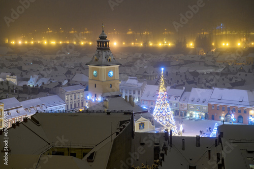 Aerial view of Brasov old town square and Christmas tree on a quiet winter night