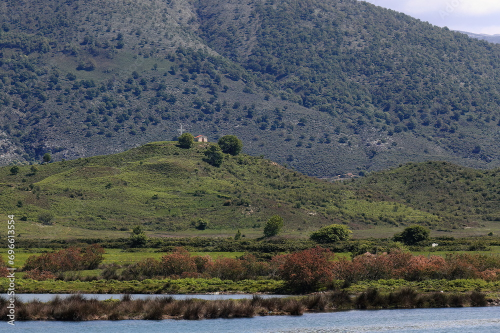 View east across the lagoon from the basilica area to the hermitage atop Maja Dhiminister mount, Butrint archaeological site. Sarande-Albania-159