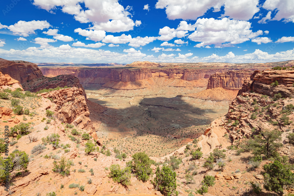 Panoramic view from of Aztec Butte of the surrounding canyon, vegetation and mesa of Canyonlands Nation Park in the arid, desert Utah environment during spring 