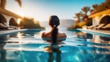Luxury swimming pool spa resort travel honeymoon destination woman relaxing in infinity pool at hotel nature background summer holiday. 