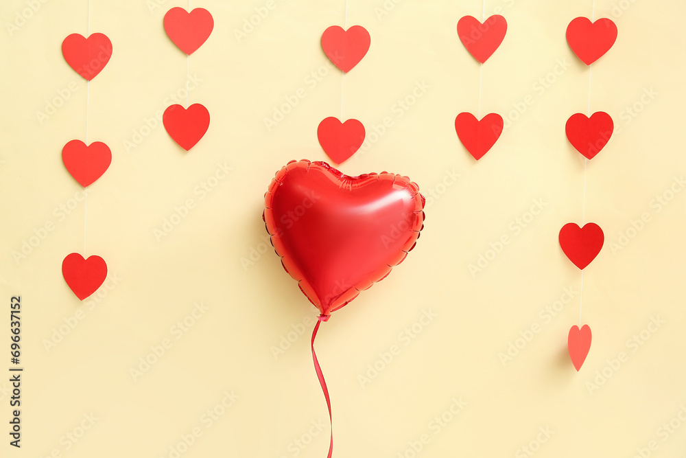Heart shaped air balloon and garland on yellow background. Valentine's day celebration