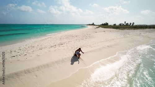 lonely brunette woman in white enjoy beach jouney sit shore beach, Drone shot Cayo de Agua Los Roques photo