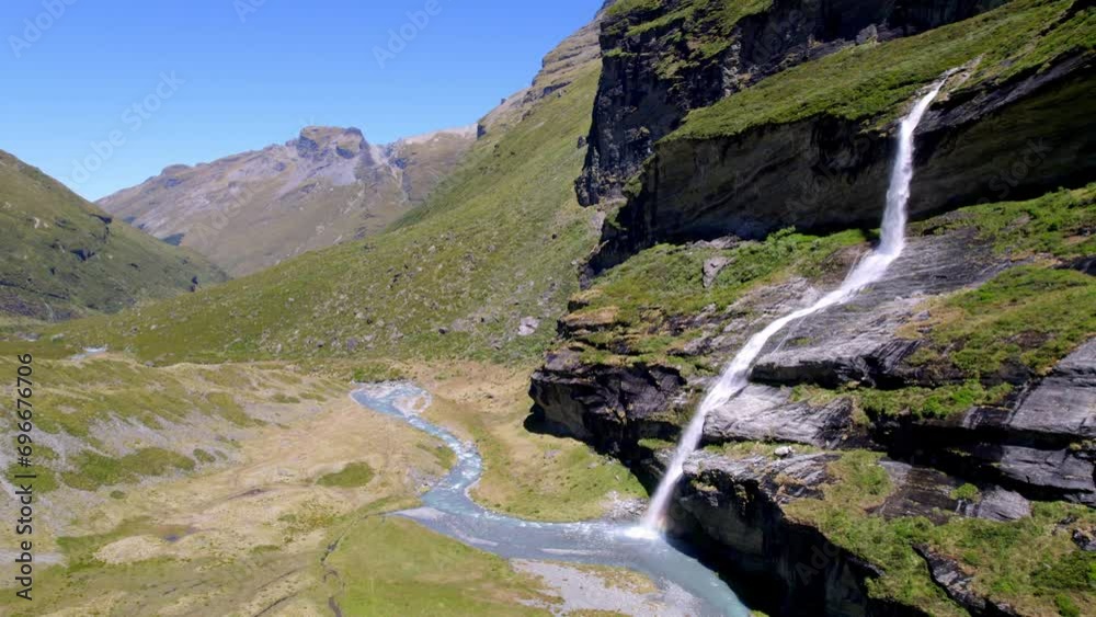 Aerial UHD tracking shot towards a rugged waterfall near Queenstown New Zealand Aerial UHD tracking shot towards a rugged waterfall near Queenstown New Zealand