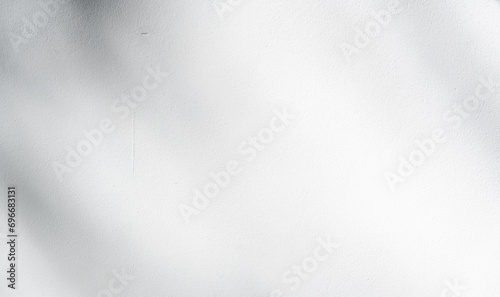 Empty Grey white Concrete wall texture Background with blurred shadow light leaves overlay well space product background or banner photo