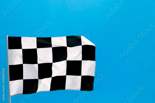 Checkered flag waving on blue background