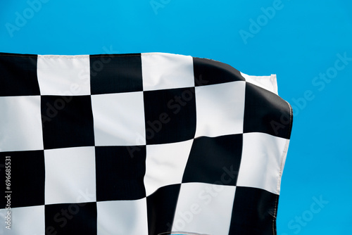 Checkered flag waving on blue background