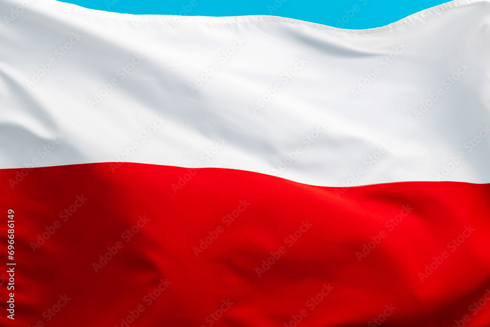 Naklejka premium Poland flag waving on blue background