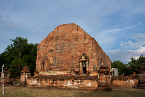 Ancient ruins ubosot ordination hall and antique old ruin stupa chedi for thai people traveler travel visit respect myth mystical in Wat Maheyong temple at Historic Heritage site in Ayutthaya Thailand photo