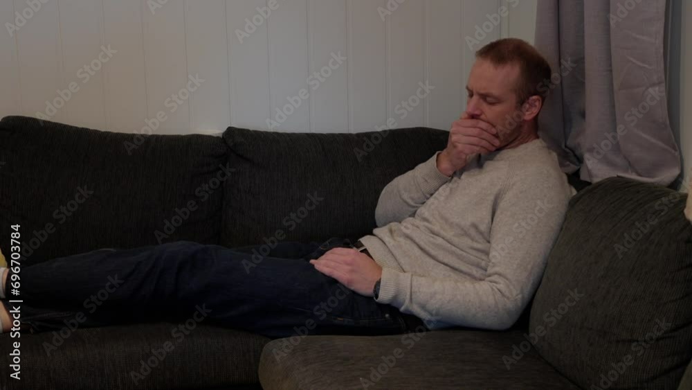 Sick Day, Man Coping with Cold and Flu Symptoms in Sofa Corner Sick Day, Man Coping with Cold and Flu Symptoms in Sofa Corner