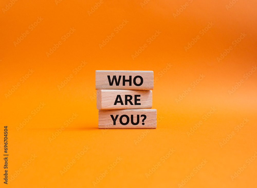 Who are You symbol. Concept words Who are You on wooden blocks. Beautiful orange background. Business and Who are You concept. Copy space. - obrazy, fototapety, plakaty 