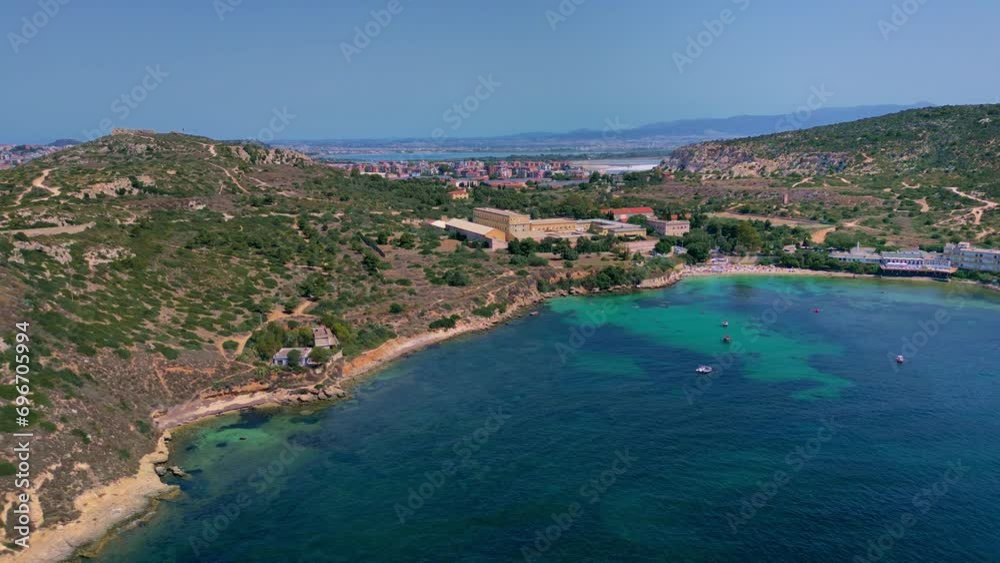 Following the sandy coastline along Spiaggia Calamosca beach, in Sardinia, Italy Following the sandy coastline along Spiaggia Calamosca beach, in Sardinia, Italy