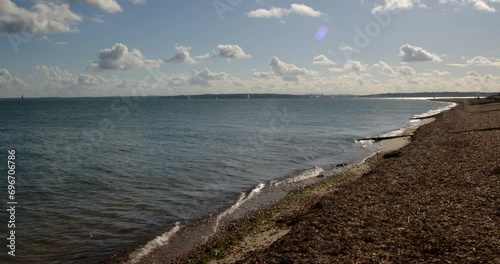 shot of the shingle beach looking towards the Isle of Wight at Calshot spit by the Solent, Southampton photo