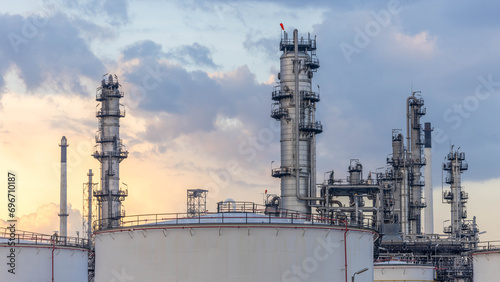 Oil and gas industrial refinery at twilight, Oil refinery and Petrochemical plant pipeline steel, Refinery factory oil storage tank and pipeline steel at twilight.